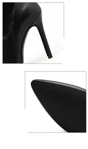 Detail view of black pointed toe high heel boot with stiletto heel and matte finish