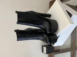 Detailed side view of black chunky high heel platform Chelsea boots with 16cm heel