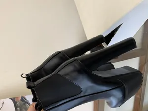 Close-up profile of women's black 16cm ultra-high block heel platform Chelsea boots.