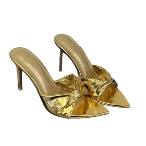 Elegant gold metallic pointed toe high heel mule sandals with twisted strap detail