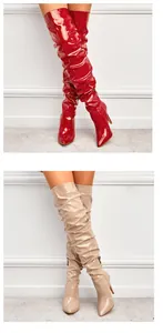 Vue détaillée de bottes au-dessus du genou en cuir verni rouge et beige à talons aiguilles.