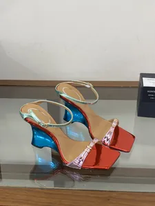 Close-up of glossy metallic color-block wedge sandals featuring a stylish square toe