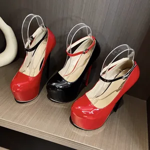 Close-up of 16cm red and black patent leather platform high heels on wooden shelf