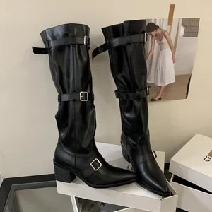 Black pointed-toe slouchy knee-high boots with multi-buckle straps and chunky heel