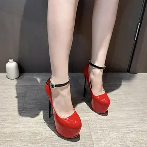 Close-up of red patent leather high heels with 16cm stiletto and black ankle strap
