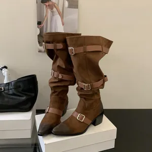 Stylish brown suede-like slouchy Western boots with buckle straps and pointed toe.
