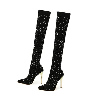 Elegant black over-the-knee boots with sparkling rhinestones and gold stiletto heels.