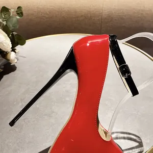 Detailed view of 16cm red patent leather stiletto heel and black ankle strap buckle.