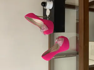 Elegant pink platform high heels with luxury rhinestone bows and thin stiletto heels