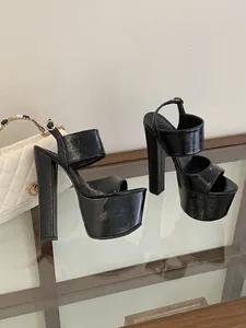 Detailed view of sexy black patent leather platform sandals with high block heels for stage