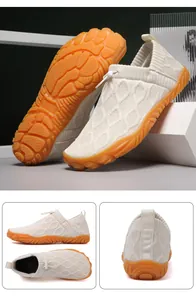 Detail view of breathable flyknit hiking shoes with non-slip orange rubber soles