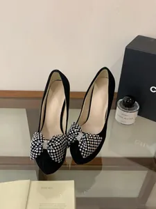 Elegant black suede platform high heels with sparkling rhinestone bow detail