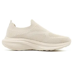 Detailed side view of beige breathable flyknit slip-on sneaker with thick foam sole