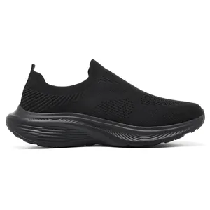 Side view detail of black breathable fly-knit slip-on walking shoes
