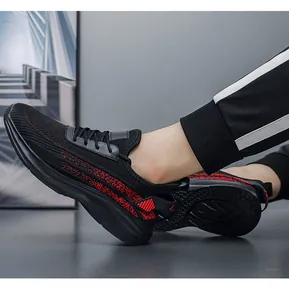 Close-up of men's breathable fly-knit athletic sneakers in black and red