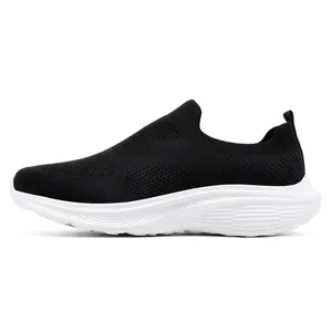 Side view of black breathable fly-knit slip-on sneaker with white sole