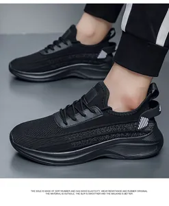 Macro view of black breathable mesh sneakers with soft rubber sole on feet