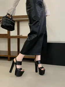 Side view of sexy black high platform sandals with chunky heels for runway and parties.