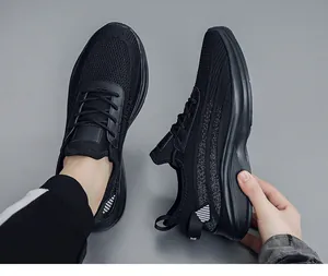 Close-up detail showing breathable black fly-knit men's sneakers with soft rubber sole