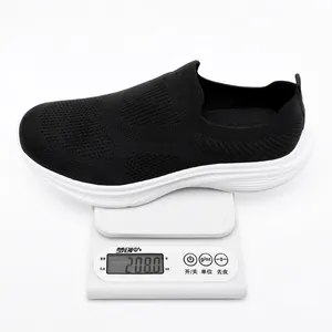 Lightweight black breathable flyknit slip-on sneaker weighing 208g on white scale