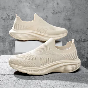 Side detail of breathable fly-knit slip-on casual sneakers for men in cream beige