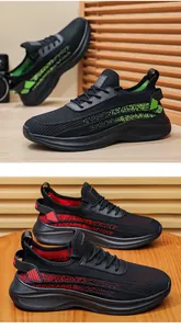 Detailed view of breathable flyknit sports shoes in black with red and green accents.