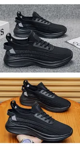 Detailed view of black breathable fly-knit mesh sports shoes with flexible soles