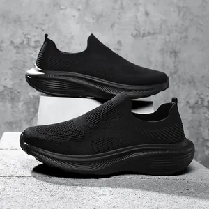 Side view of black men's breathable fly-knit slip-on sneakers with textured chunky soles