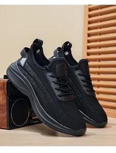 Close-up view of black breathable fly-knit mesh material on men's athletic shoes