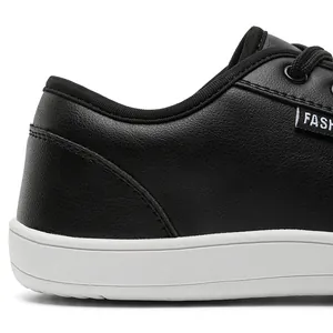 Macro view showing the heel texture and white rubber sole of black leather barefoot shoes