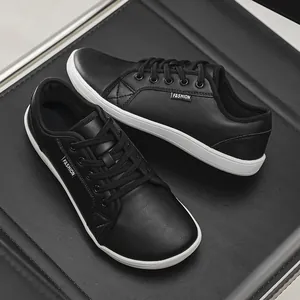 Detail view of black leather barefoot sneakers with wide toe box and lace-up design