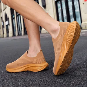 Close-up detailed view of breathable tan knit slip-on sneakers for men with wide fit