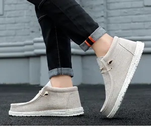 Close-up side view of beige high-top canvas loafers with speckled white soles