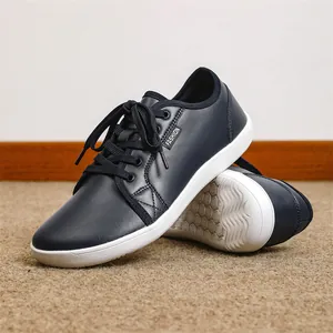 Detailed view of navy blue leather barefoot shoes with wide toe and non-slip sole