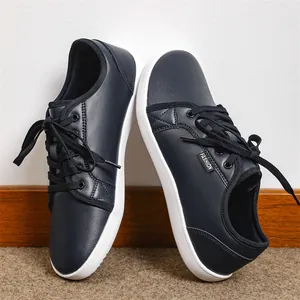 Detailed view of dark blue leather barefoot shoes with wide toe box and white flat sole