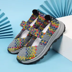 Side view of colorful woven elastic women's shoes with breathable hollow design and grey sole.