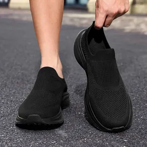 Detailed close-up showing breathable mesh texture of black men's slip-on athletic sneakers