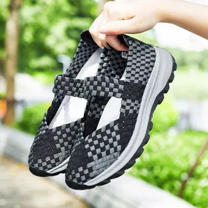Close-up of lightweight woven slip-on shoes with breathable elastic checkered pattern.