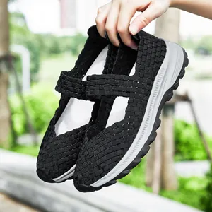 Detail of breathable black woven women's casual shoes with flexible slip-on design