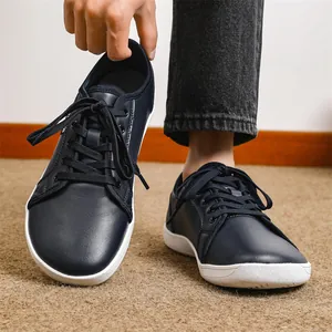 Close-up of navy blue leather barefoot shoes with wide toe box and flat white sole
