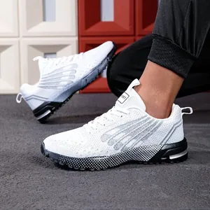 Detailed side view of breathable white mesh mens running shoes showing textured black soles