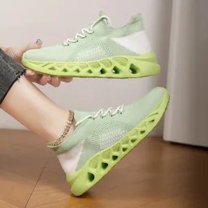 Breathable light green flyknit casual running shoes with hollow shock-absorbing sole