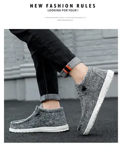 Side view of stylish gray high-top canvas loafers with speckled white soles shown on feet
