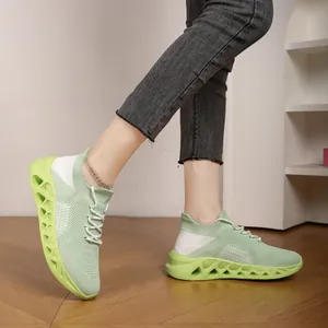 Detailed view of breathable green fly-knit mesh running shoes for men in a lifestyle setting