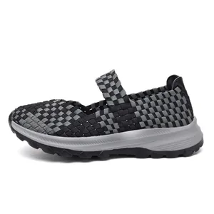 Detail view of black and grey woven elastic Mary Jane shoes with thick sport soles.