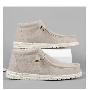 Detail shot of beige high-top canvas loafers with speckled soles and toggle laces