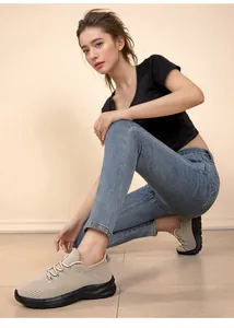 Comfortable beige flyknit sneakers for women with durable black sole in casual setting