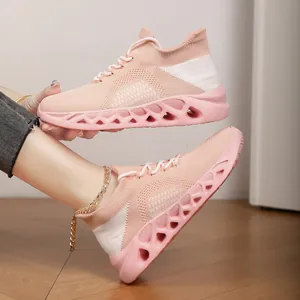 Macro view of a pink flyknit breathable running shoe featuring a hollow sole design.