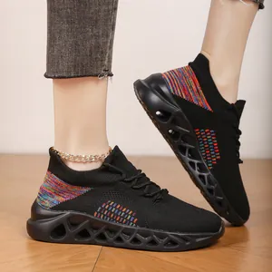 Close-up of black fly-woven running shoes featuring rainbow knit and hollowed-out soles.