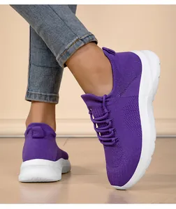 Detail view of purple women's flying knit sock sneakers with a white lightweight sole